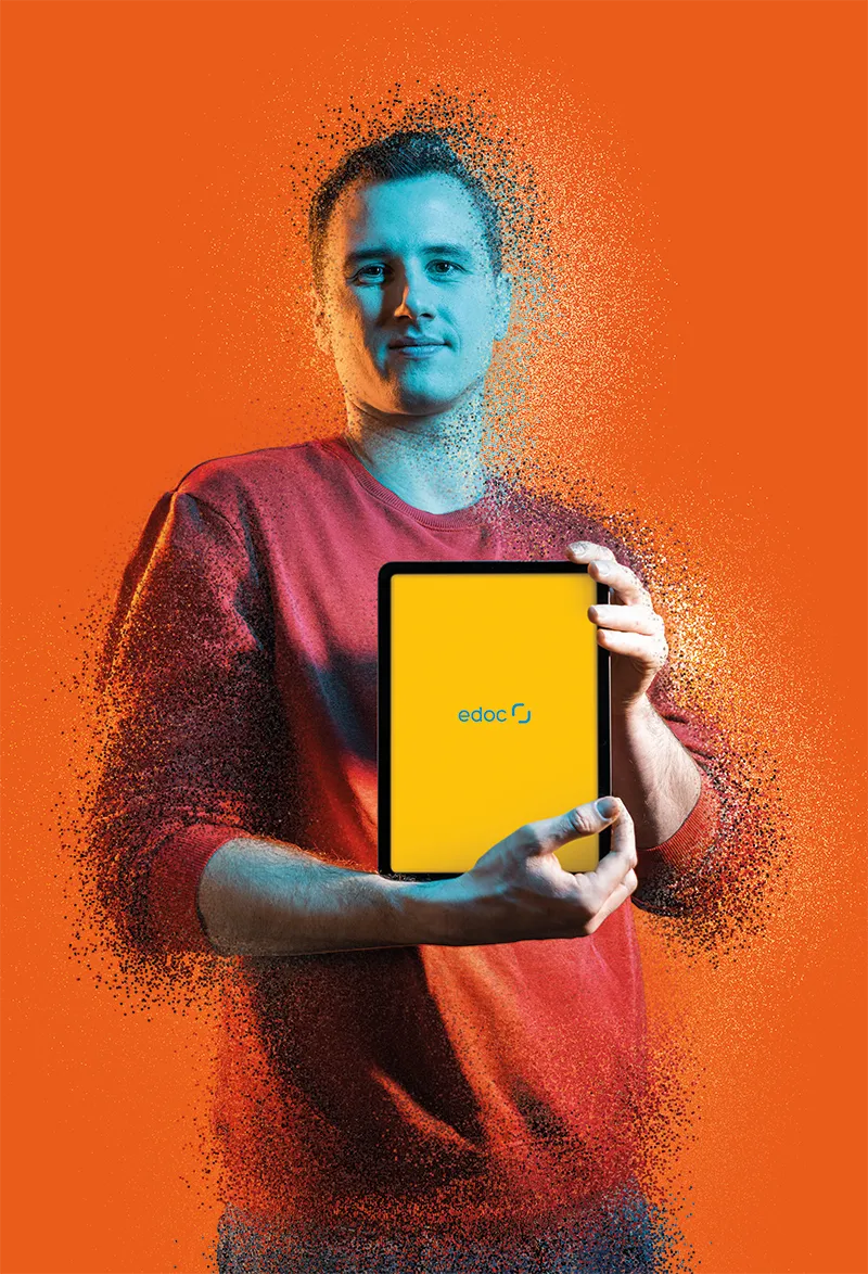 Mann hält Tablet und lächelt in die Kamera, Display zeigt neues Markenbild